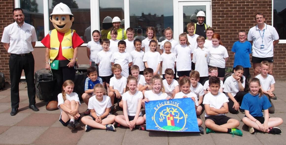 Our Ian Martin, Mascot, Martyn Currie, Jonathan Green and teacher David Ivinson alongiside some of Beaconside pupils